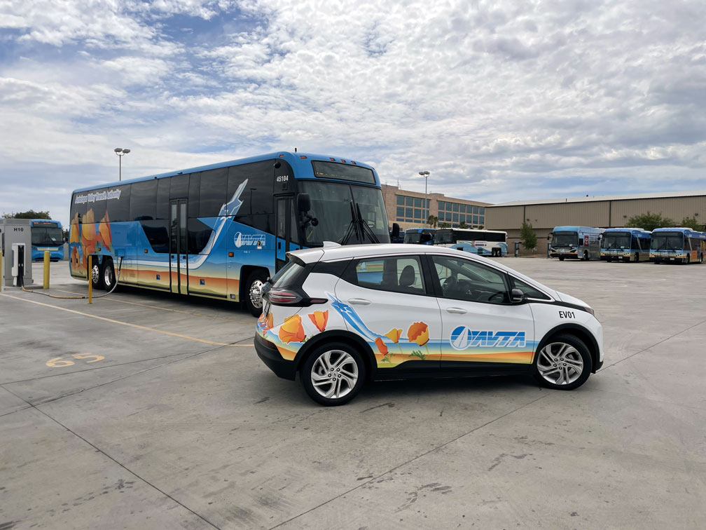 AVTA Electric Chevrolet Bolt with AVTA bus in background